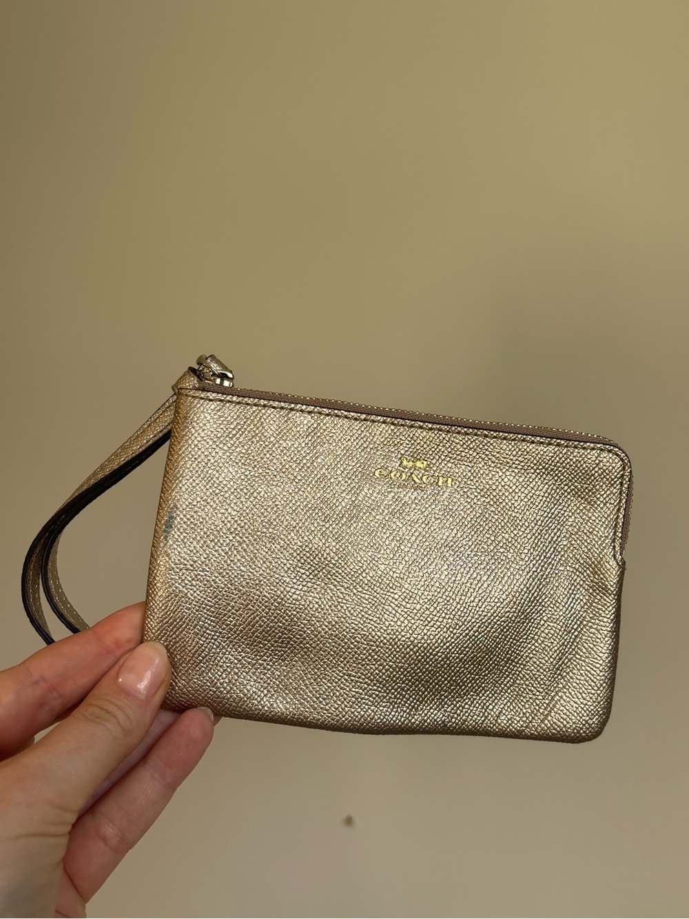 Coach metallic gold wristlet with brown interior